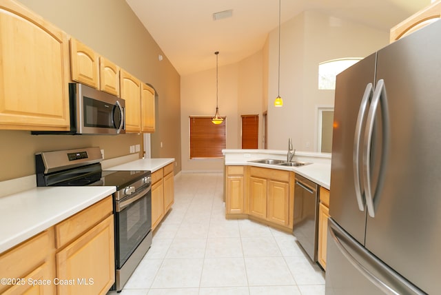 kitchen with light brown cabinets, light countertops, light tile patterned floors, stainless steel appliances, and a sink