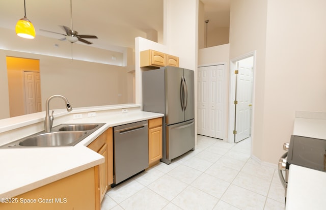 kitchen featuring a ceiling fan, light brown cabinetry, a sink, stainless steel appliances, and light tile patterned floors