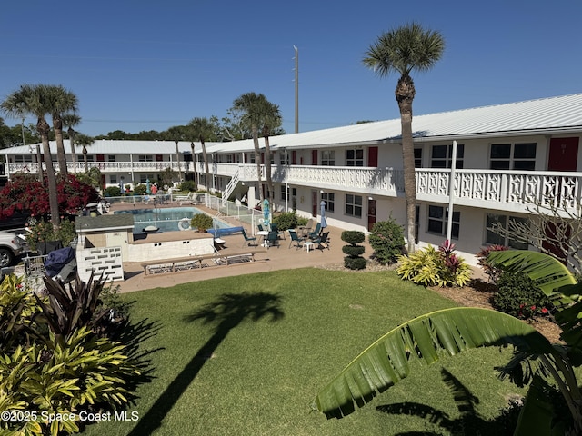 exterior space featuring a patio area, a swimming pool, and a yard