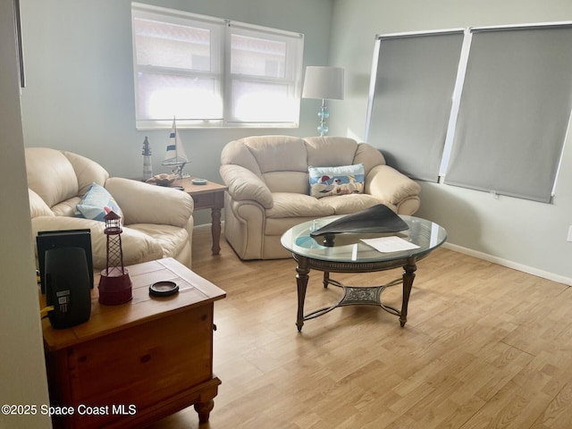 living room featuring light wood-type flooring and baseboards