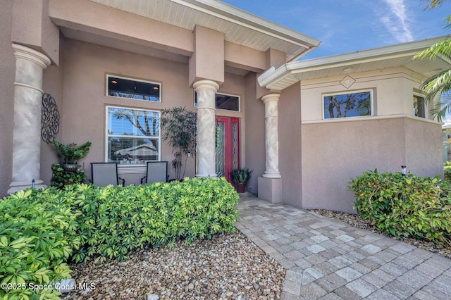 view of exterior entry with stucco siding