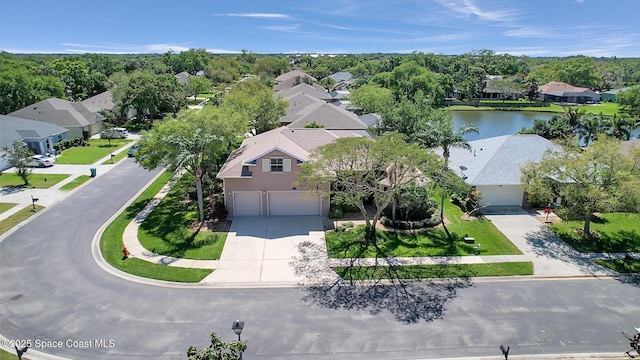 birds eye view of property featuring a residential view and a water view