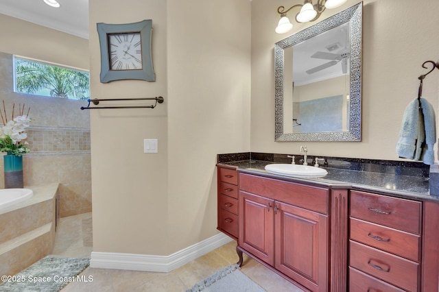 full bathroom with vanity, tiled tub, baseboards, and tile patterned flooring