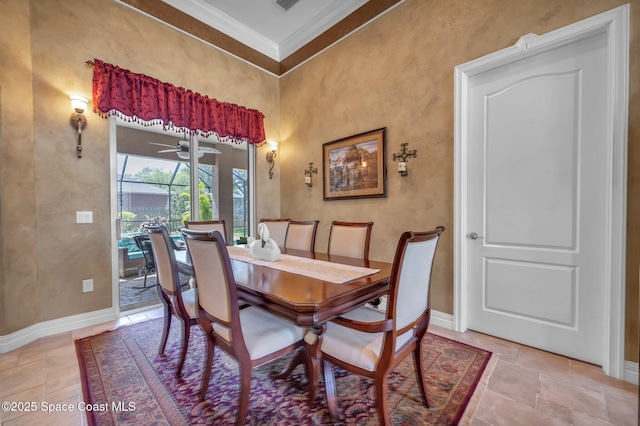 dining room featuring visible vents, baseboards, ornamental molding, stone tile floors, and a ceiling fan