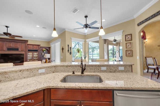 kitchen featuring visible vents, arched walkways, a sink, dishwasher, and crown molding