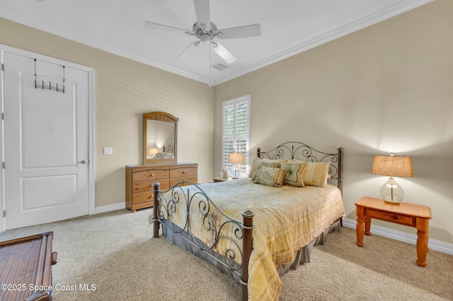 carpeted bedroom featuring visible vents, baseboards, ceiling fan, and crown molding