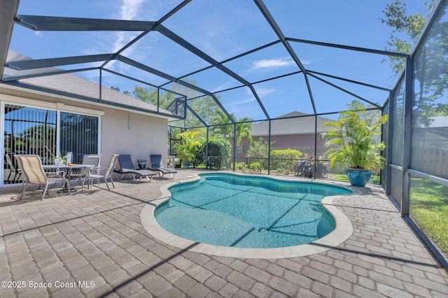 outdoor pool with a lanai and a patio