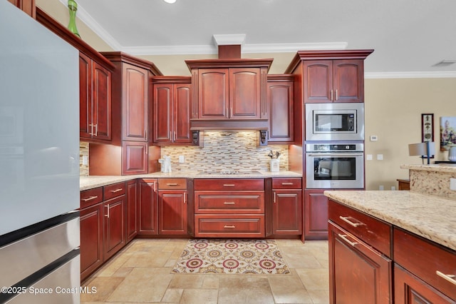 kitchen with dark brown cabinets, light stone countertops, ornamental molding, decorative backsplash, and stainless steel appliances