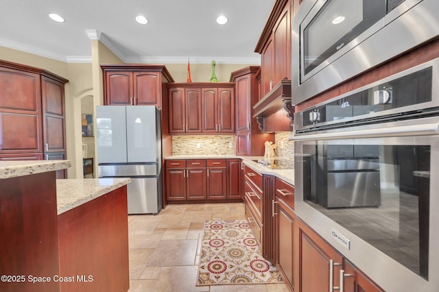 kitchen featuring appliances with stainless steel finishes, crown molding, decorative backsplash, custom exhaust hood, and dark brown cabinets