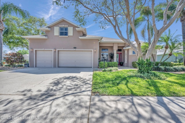 view of front of house featuring a garage, driveway, and stucco siding