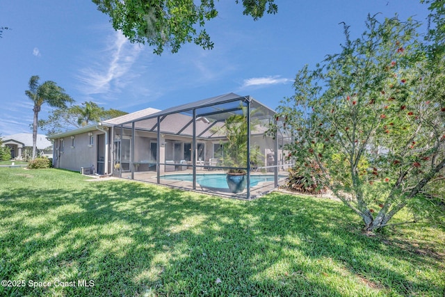 outdoor pool with glass enclosure and a lawn