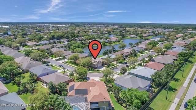 drone / aerial view with a residential view and a water view