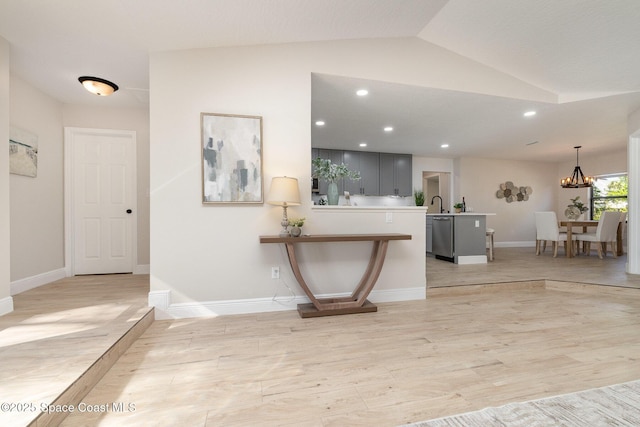 corridor with vaulted ceiling, recessed lighting, light wood-style floors, and baseboards