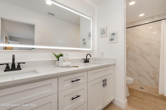 bathroom featuring a sink, curtained shower, toilet, and visible vents