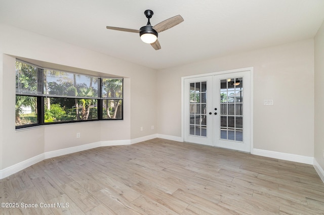 unfurnished room with light wood finished floors, french doors, a ceiling fan, and baseboards