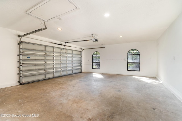 garage with recessed lighting, a garage door opener, and baseboards