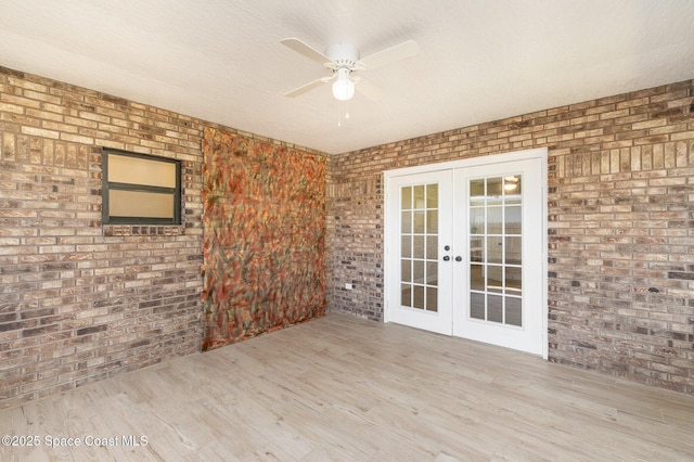 wooden terrace featuring french doors and a ceiling fan