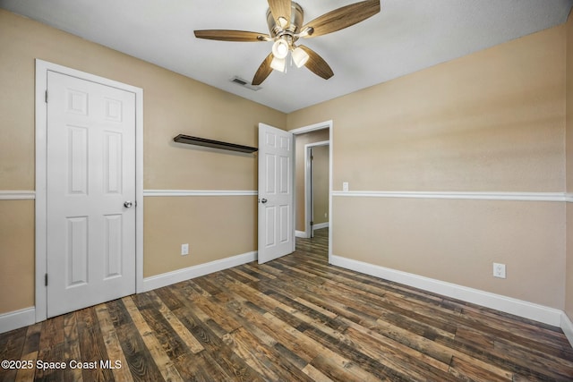 unfurnished bedroom featuring visible vents, ceiling fan, baseboards, and wood finished floors