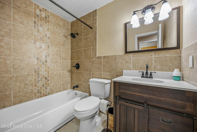 full bathroom featuring vanity,  shower combination, tile walls, toilet, and tile patterned floors