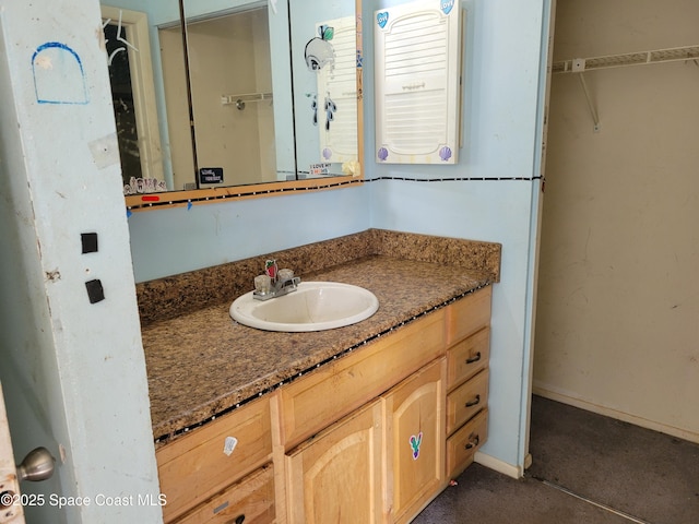 bathroom with baseboards and vanity