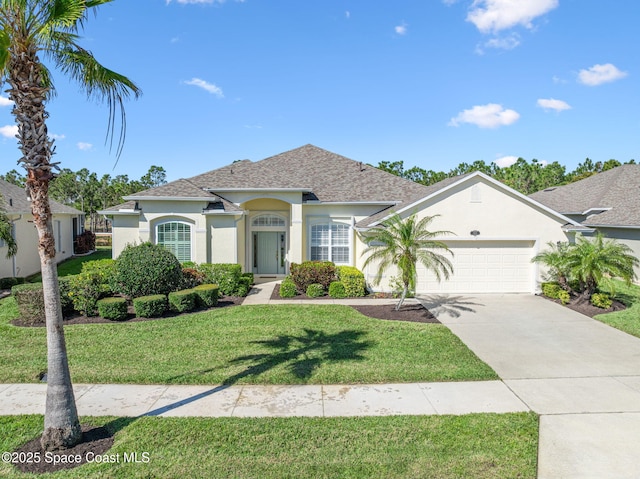 view of front of property featuring a front yard, roof with shingles, stucco siding, a garage, and driveway