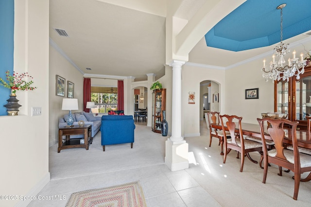 interior space featuring arched walkways, light colored carpet, crown molding, and ornate columns