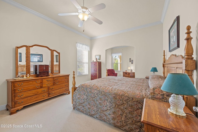 bedroom with a ceiling fan, carpet, baseboards, arched walkways, and crown molding