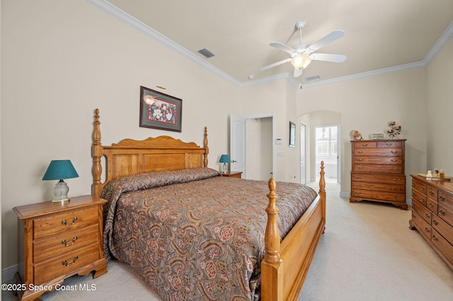 bedroom with arched walkways, visible vents, light carpet, and ornamental molding