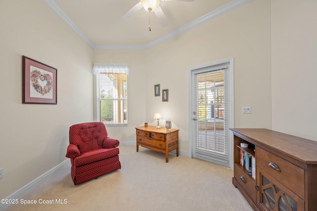 living area featuring a wealth of natural light, baseboards, light colored carpet, and crown molding