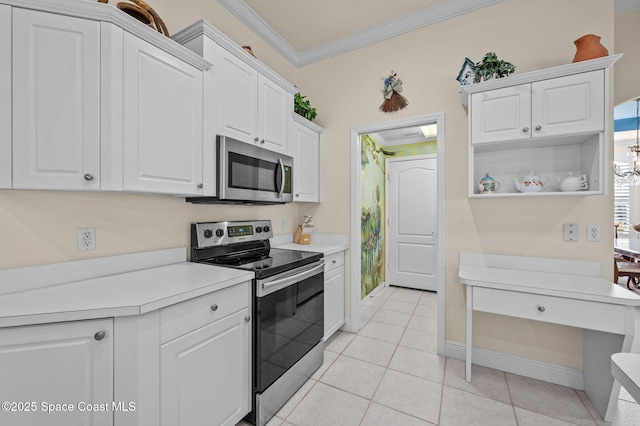 kitchen with white cabinets, stainless steel appliances, and ornamental molding