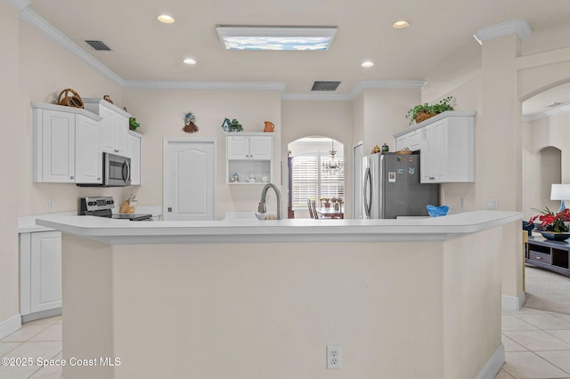 kitchen with arched walkways, visible vents, stainless steel appliances, and light tile patterned floors