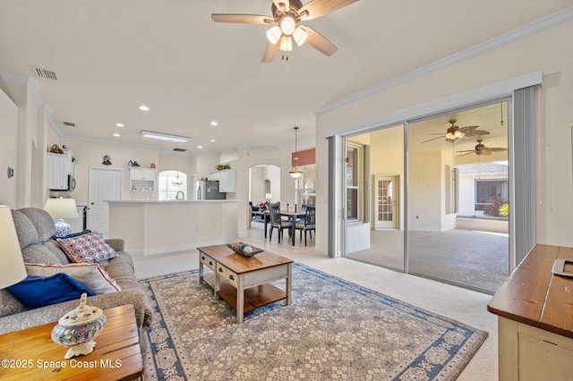 living room with visible vents, recessed lighting, arched walkways, ornamental molding, and light carpet