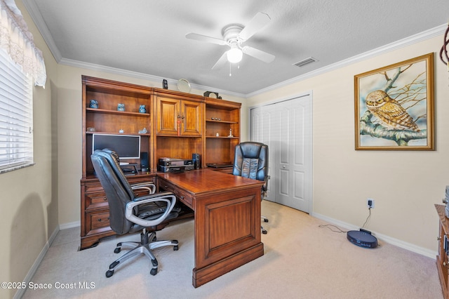 home office featuring crown molding, baseboards, visible vents, and light carpet