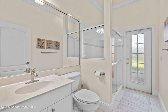 bathroom featuring tile patterned flooring, baseboards, toilet, a stall shower, and vanity