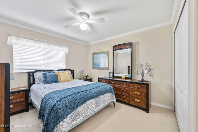 bedroom featuring baseboards, light colored carpet, ornamental molding, a closet, and a ceiling fan