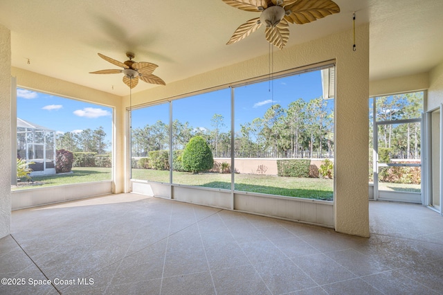 unfurnished sunroom with plenty of natural light and ceiling fan