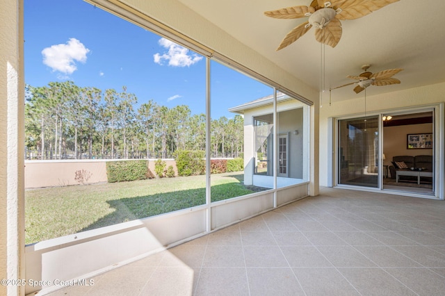 unfurnished sunroom with a ceiling fan