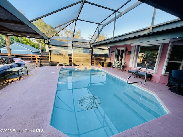 pool with glass enclosure and a patio area