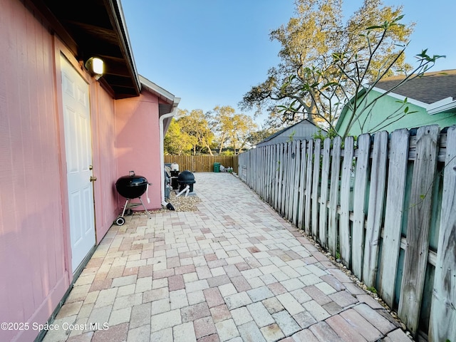 view of patio with a fenced backyard and grilling area