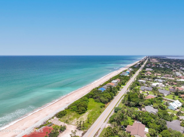 drone / aerial view featuring a view of the beach and a water view