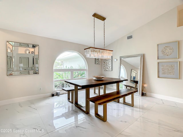 dining space with visible vents, marble finish floor, high vaulted ceiling, and baseboards