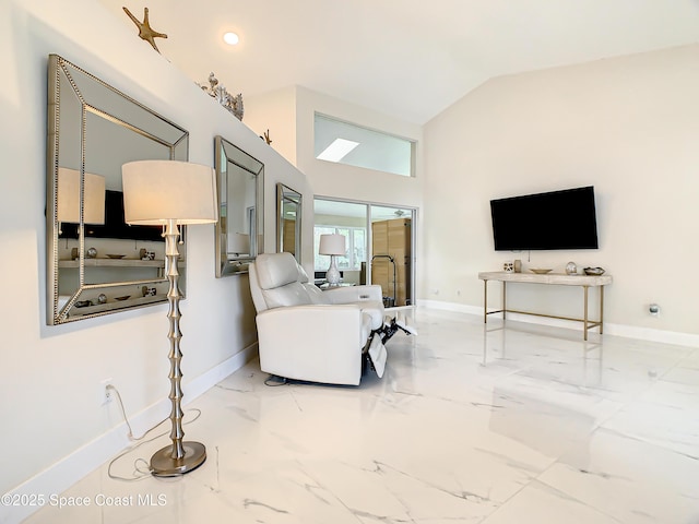 living room featuring marble finish floor, lofted ceiling, and baseboards