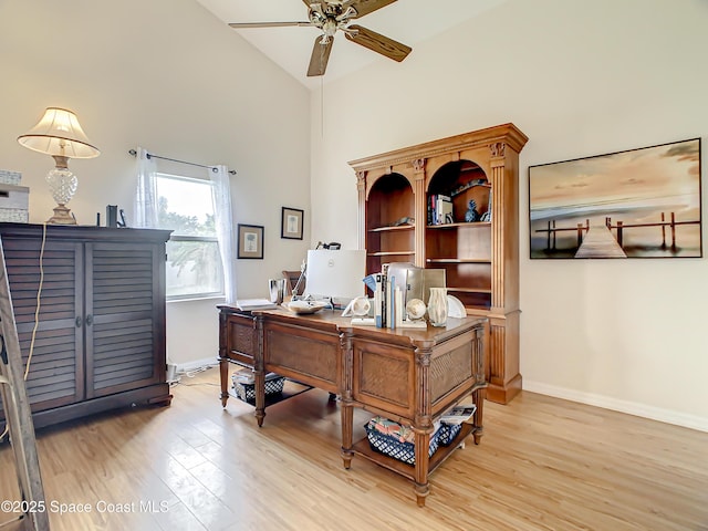 office area with ceiling fan, high vaulted ceiling, light wood-type flooring, and baseboards