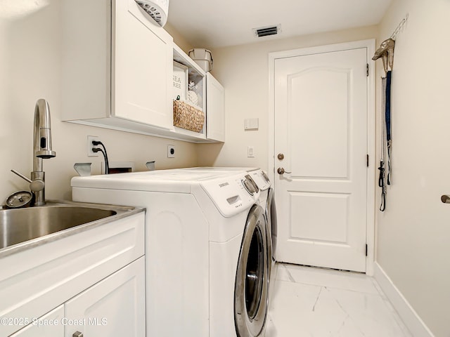 laundry room with visible vents, cabinet space, a sink, marble finish floor, and washer and clothes dryer