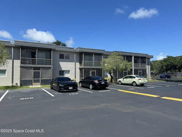 view of building exterior with uncovered parking