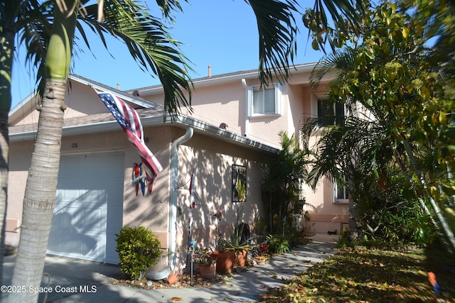 126 Plover Ln Unit 632, Rockledge, FL 32955 - view of home's exterior featuring a garage and stucco siding