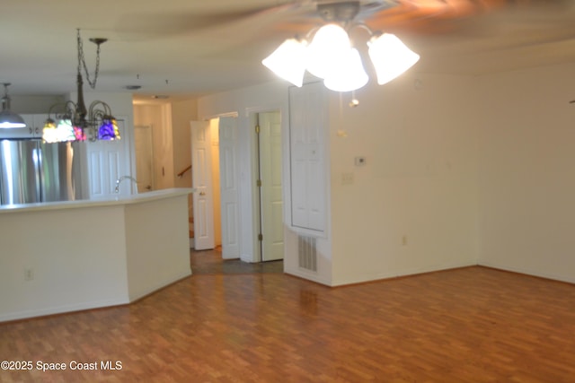 126 Plover Ln Unit 632, Rockledge, FL 32955 - spare room with wood finished floors, ceiling fan, a chandelier, baseboards, and a sink