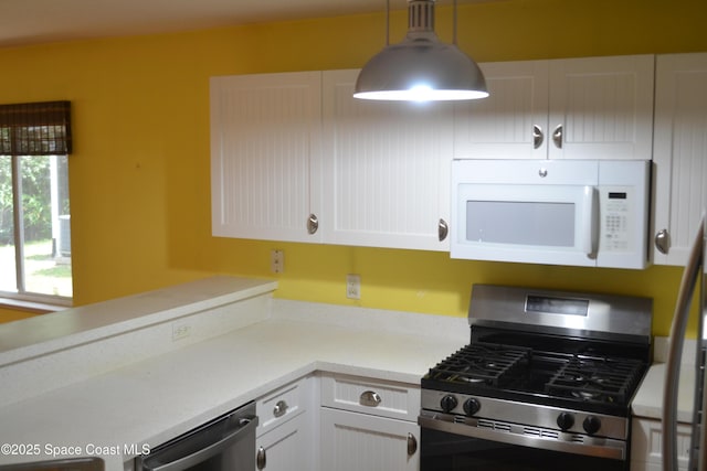 126 Plover Ln Unit 632, Rockledge, FL 32955 - kitchen with appliances with stainless steel finishes, white cabinets, light countertops, and hanging light fixtures