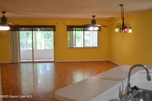 126 Plover Ln Unit 632, Rockledge, FL 32955 - kitchen featuring ceiling fan, wood finished floors, baseboards, and hanging light fixtures