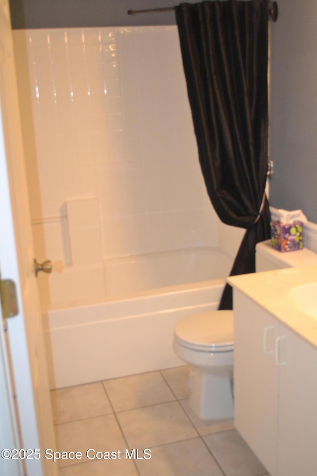 126 Plover Ln Unit 632, Rockledge, FL 32955 - bathroom featuring toilet, shower / tub combo with curtain, vanity, and tile patterned flooring